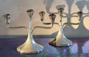 Par de elegantes candelabros de prata, cada um com três chamas